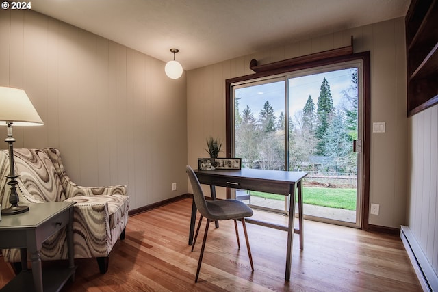 office with baseboards, baseboard heating, and light wood-style floors