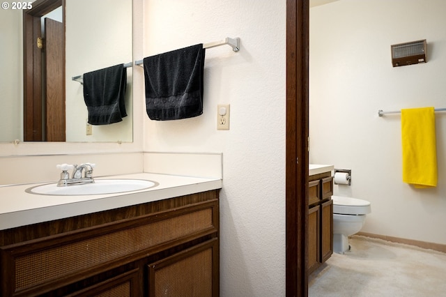 bathroom with toilet and vanity