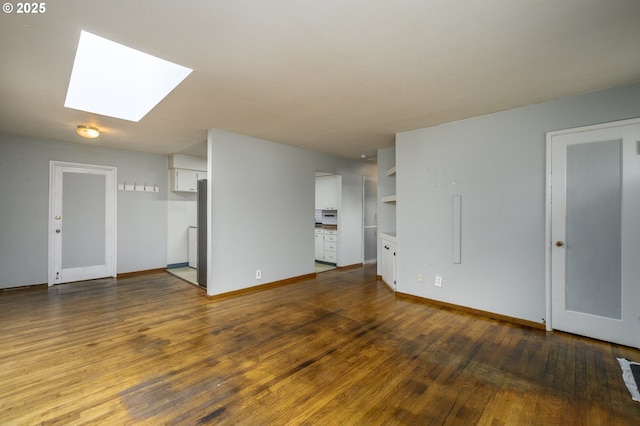 140 Canemah Rd, Oregon City, OR 97045 - unfurnished living room featuring a skylight, wood finished floors, and baseboards