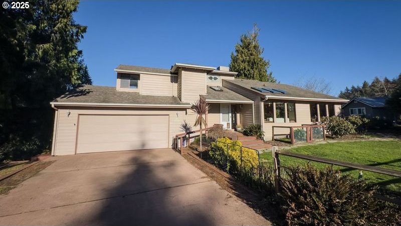 split level home featuring a garage and a front yard