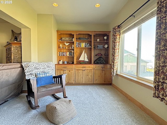 living area featuring recessed lighting, baseboards, and light carpet