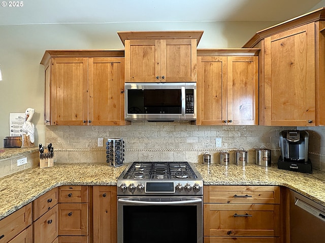 kitchen featuring light stone counters, backsplash, appliances with stainless steel finishes, and brown cabinetry