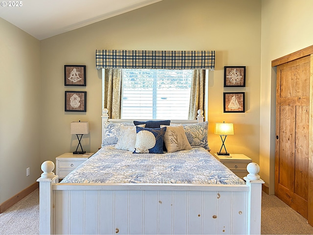 bedroom with lofted ceiling, baseboards, and light carpet