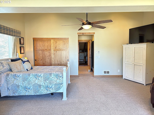 carpeted bedroom featuring visible vents, a ceiling fan, baseboards, and vaulted ceiling