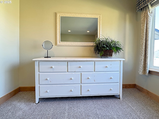 interior details with baseboards and carpet floors