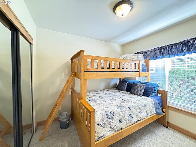 carpeted bedroom with baseboards