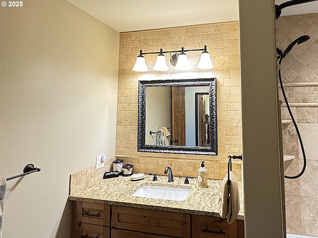 bathroom featuring decorative backsplash, vanity, and tiled shower