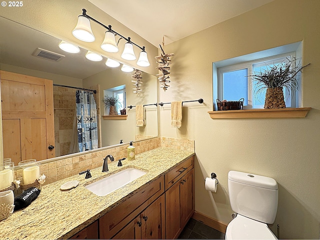 bathroom with visible vents, toilet, backsplash, baseboards, and vanity