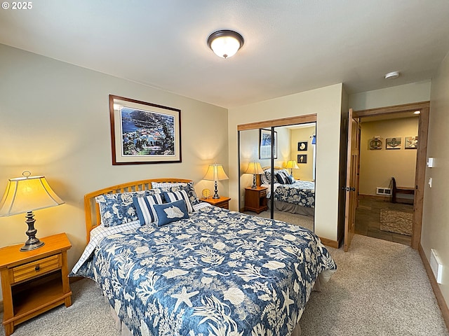 bedroom with carpet flooring, baseboards, and a closet