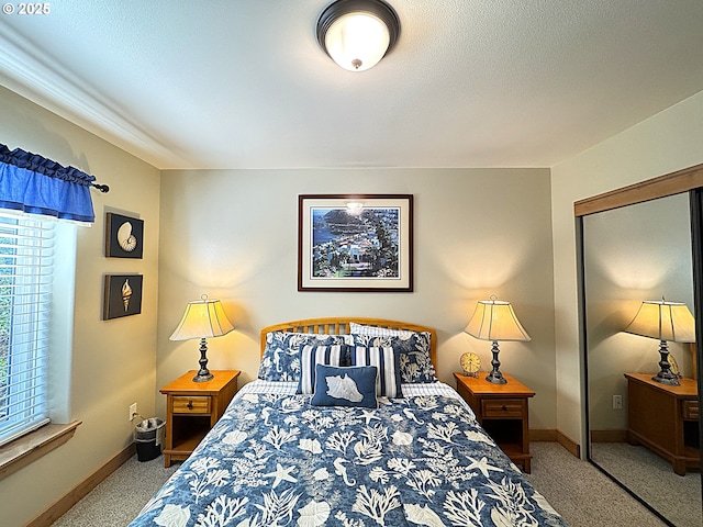 carpeted bedroom with baseboards, a closet, and a textured ceiling