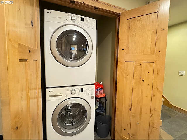 laundry area with laundry area and stacked washer / dryer