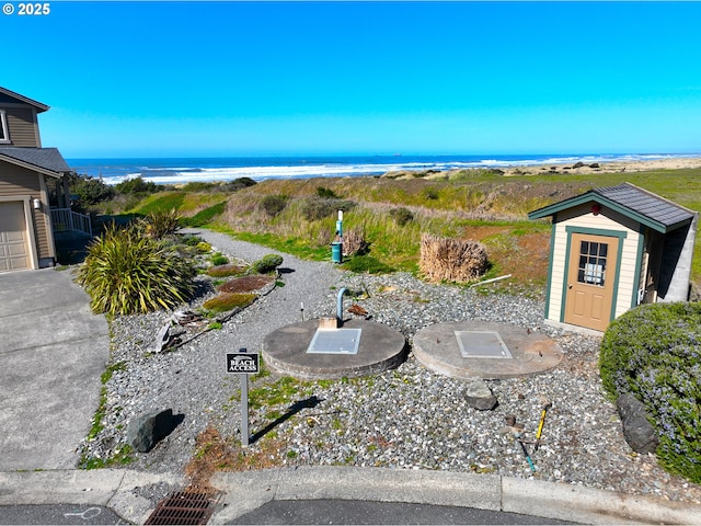 exterior space with a shed, an outdoor structure, and a water view