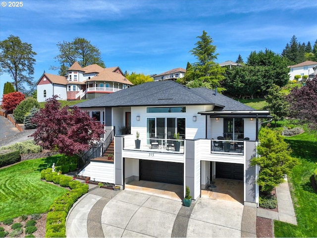 view of front of home featuring stairway, a balcony, roof with shingles, concrete driveway, and an attached garage