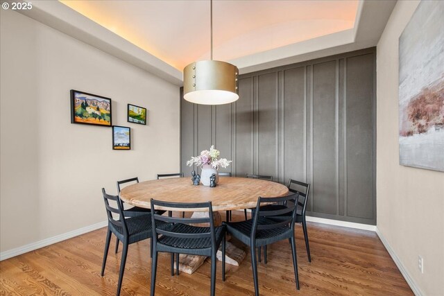 dining space with wood finished floors and baseboards