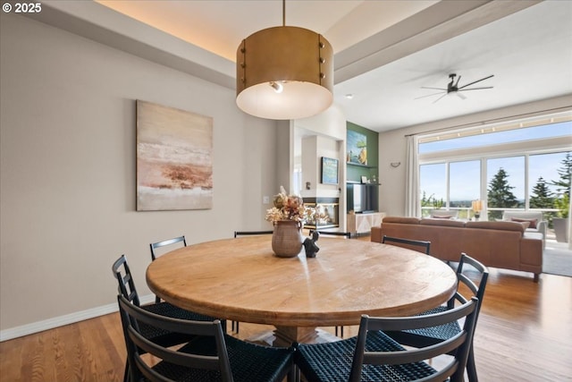 dining area with ceiling fan, wood finished floors, and baseboards