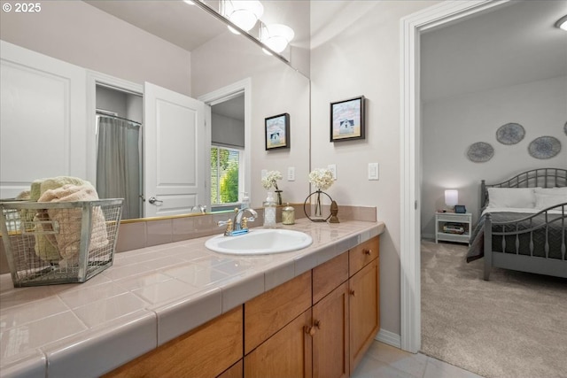ensuite bathroom with connected bathroom and vanity