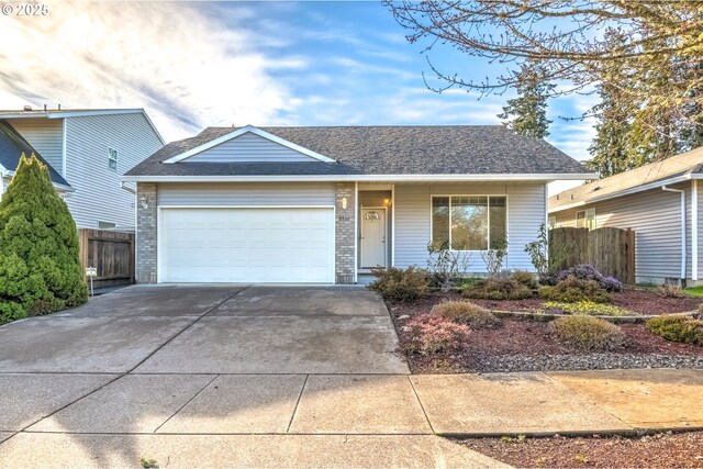 ranch-style home featuring a garage, concrete driveway, brick siding, and fence