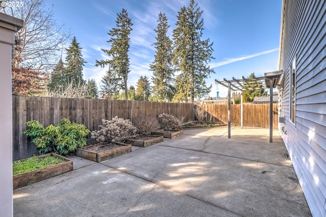 view of patio with a fenced backyard, a vegetable garden, and a pergola