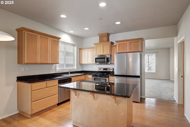 kitchen with a wealth of natural light, appliances with stainless steel finishes, a sink, and light brown cabinetry