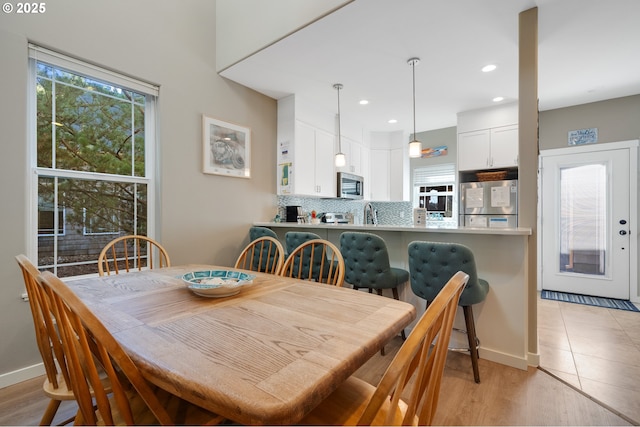 dining area with light hardwood / wood-style flooring