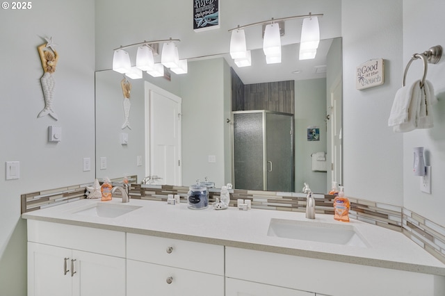 bathroom featuring vanity and an enclosed shower