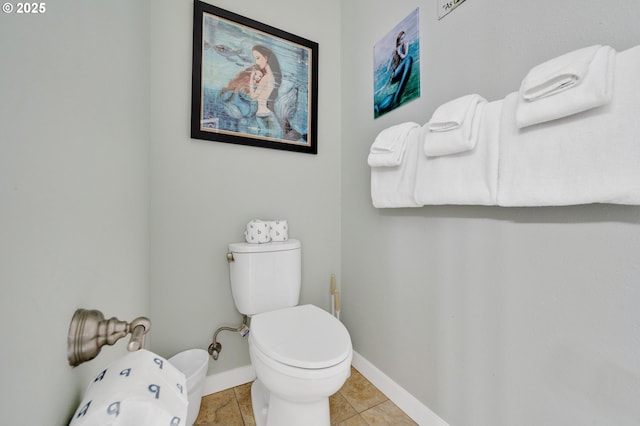 bathroom featuring a bidet, toilet, and tile patterned flooring