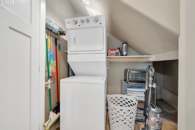 laundry area featuring stacked washing maching and dryer