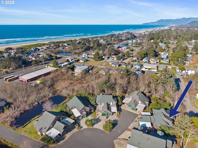 drone / aerial view with a water view and a view of the beach