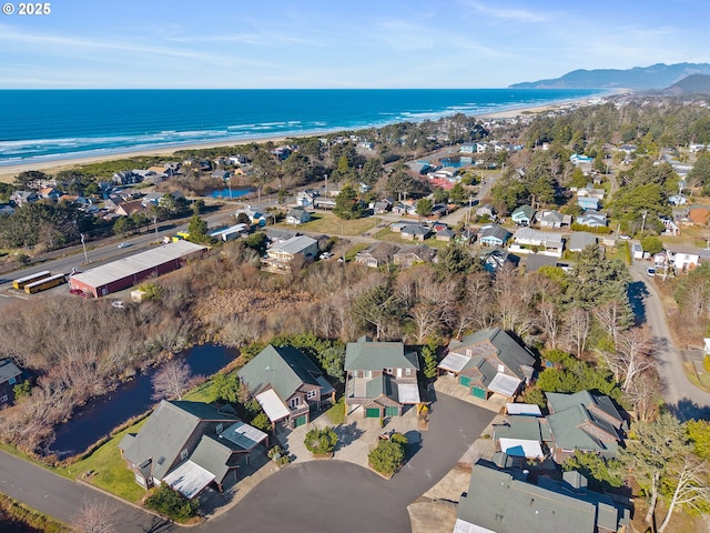 bird's eye view featuring a water view and a beach view