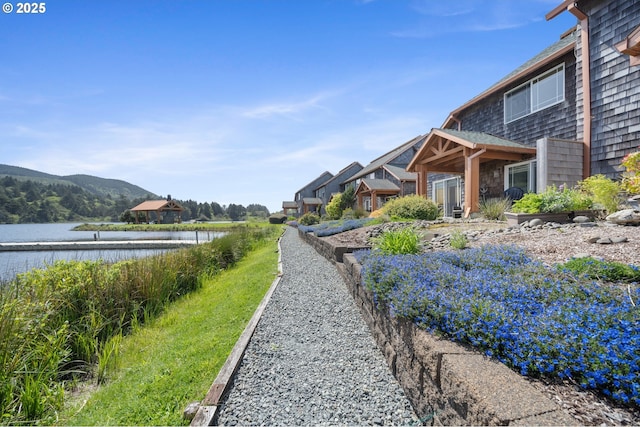 view of yard featuring a water and mountain view