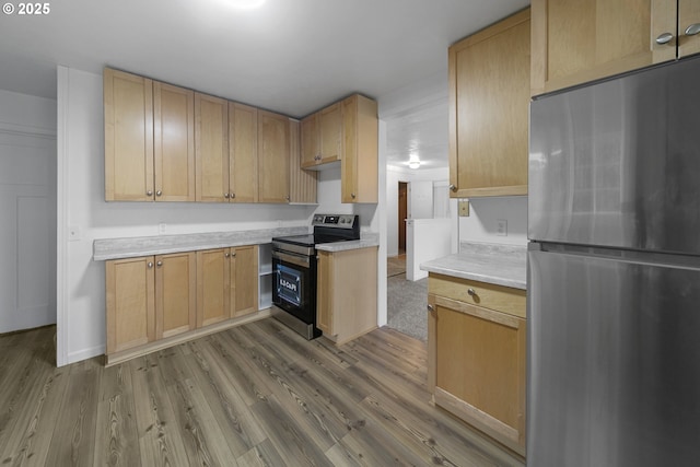 276 S 21st St, Reedsport, OR 97467 - kitchen with appliances with stainless steel finishes, light countertops, wood finished floors, and light brown cabinets