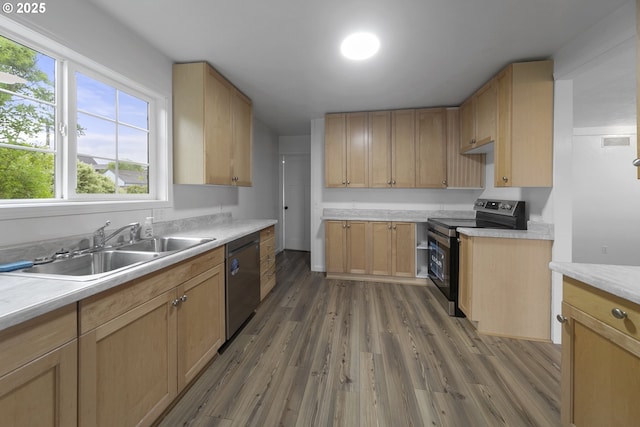276 S 21st St, Reedsport, OR 97467 - kitchen with appliances with stainless steel finishes, a sink, wood finished floors, light countertops, and light brown cabinetry