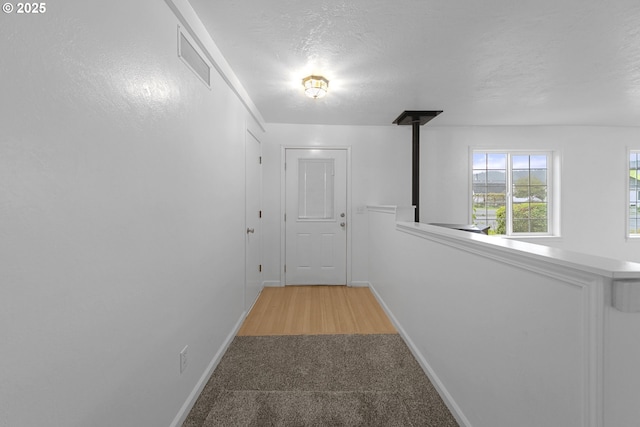 276 S 21st St, Reedsport, OR 97467 - hallway with baseboards, light colored carpet, and a textured ceiling