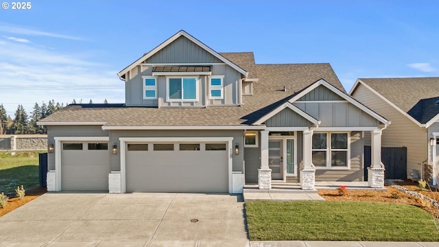 craftsman-style home featuring a porch, a garage, and a front yard