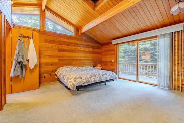 carpeted bedroom featuring multiple windows, wooden walls, access to exterior, and vaulted ceiling with beams