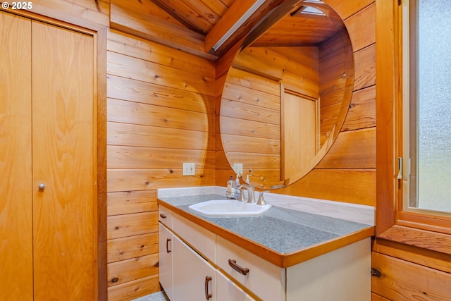 bathroom featuring vanity and wooden walls