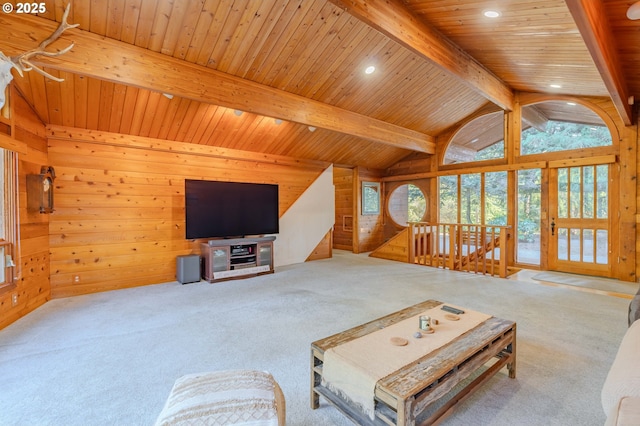 living room with lofted ceiling with beams, light colored carpet, wooden ceiling, and wooden walls