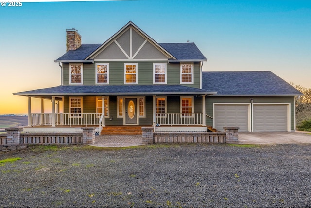 view of front facade featuring a porch and a garage