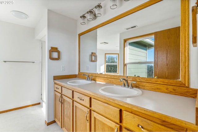 bathroom with vanity and a shower with shower door