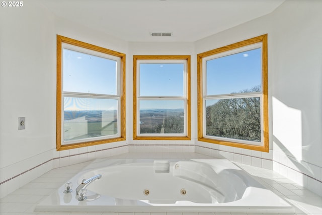 bathroom featuring tiled tub