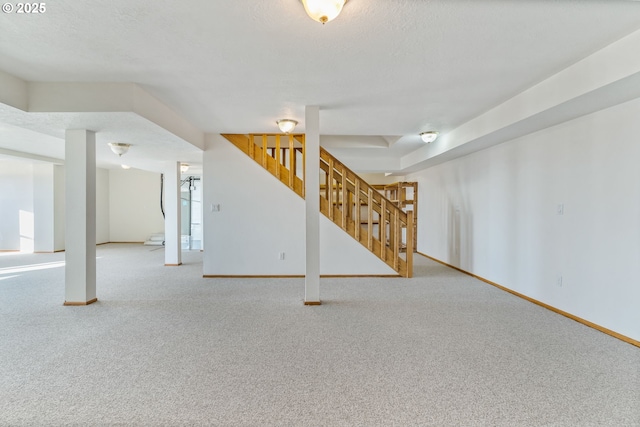 carpeted spare room with a textured ceiling