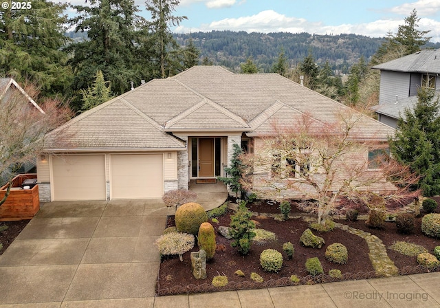 view of front of house with driveway, stone siding, and a garage