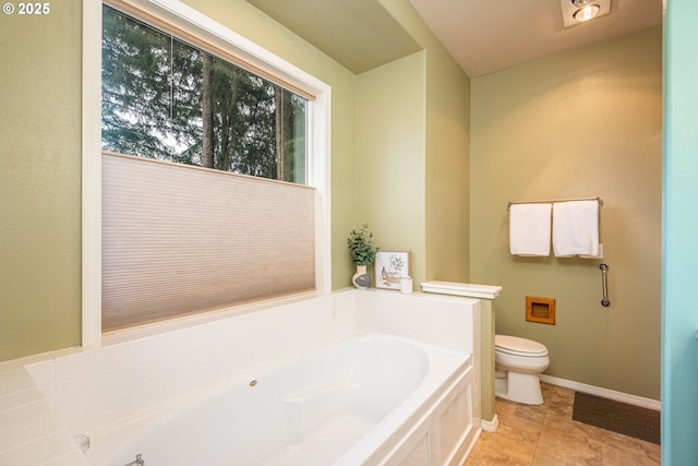 full bathroom with tile patterned floors, a garden tub, toilet, and baseboards