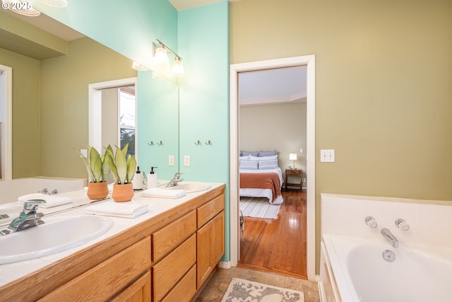 full bathroom featuring a sink, double vanity, ensuite bath, and a garden tub