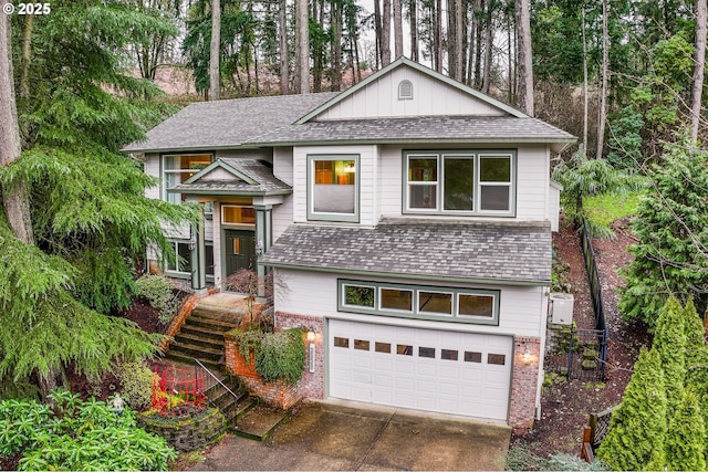 view of front of property with concrete driveway, brick siding, and an attached garage