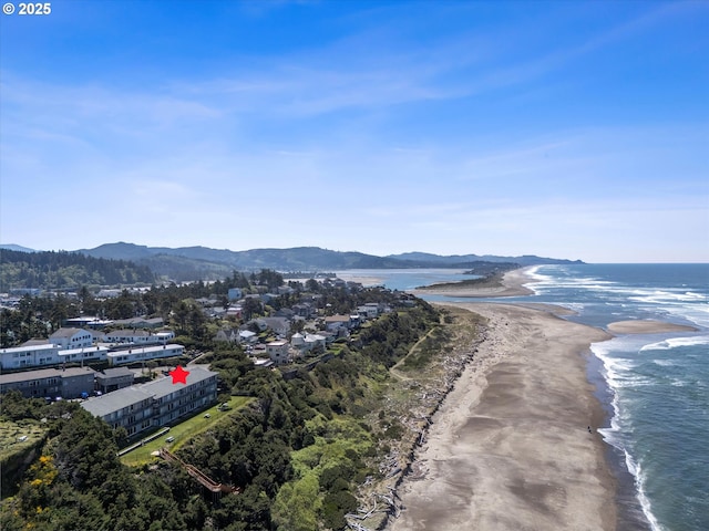 4229 SW Beach Ave Unit 27, Lincoln City, OR 97367 - drone / aerial view with a view of the beach and a water and mountain view