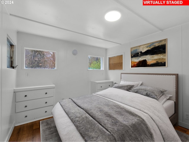 bedroom with dark wood finished floors