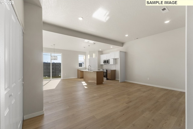 1201 NE Emerald Dr, Hermiston, OR 97838 - unfurnished living room with light wood-style floors, recessed lighting, and a chandelier