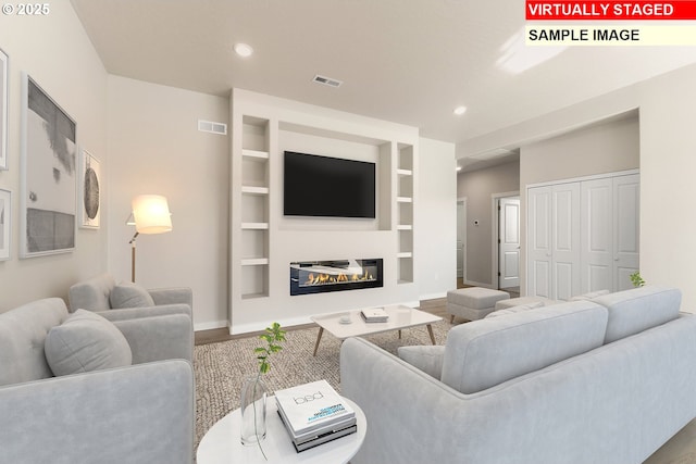 1201 NE Emerald Dr, Hermiston, OR 97838 - living room featuring wood finished floors, a glass covered fireplace, and recessed lighting