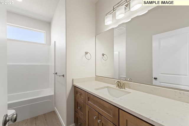 1201 NE Emerald Dr, Hermiston, OR 97838 - bathroom featuring vanity, wood finished floors, and tub / shower combination